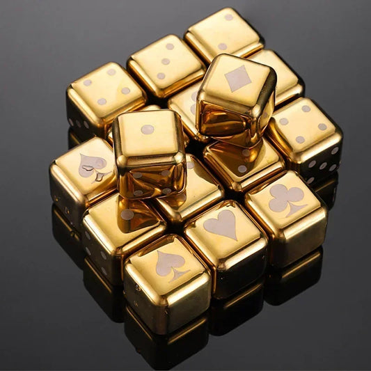 Set of 8 gold and silver stainless steel whiskey chilling cubes engraved with card suit symbols, arranged in a stack