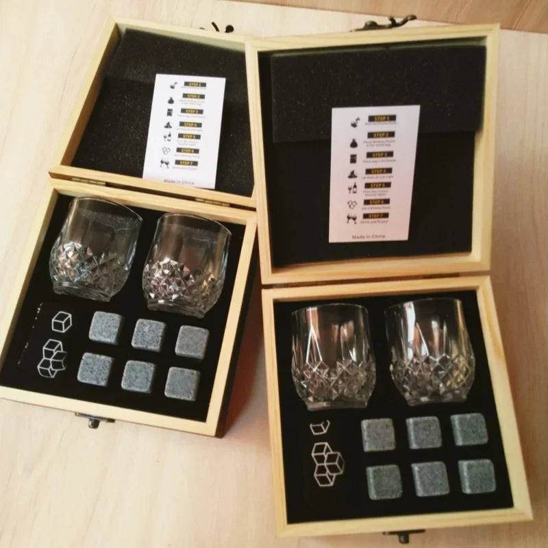 Two whiskey stones gift sets shown open with glasses, stones and instruction cards