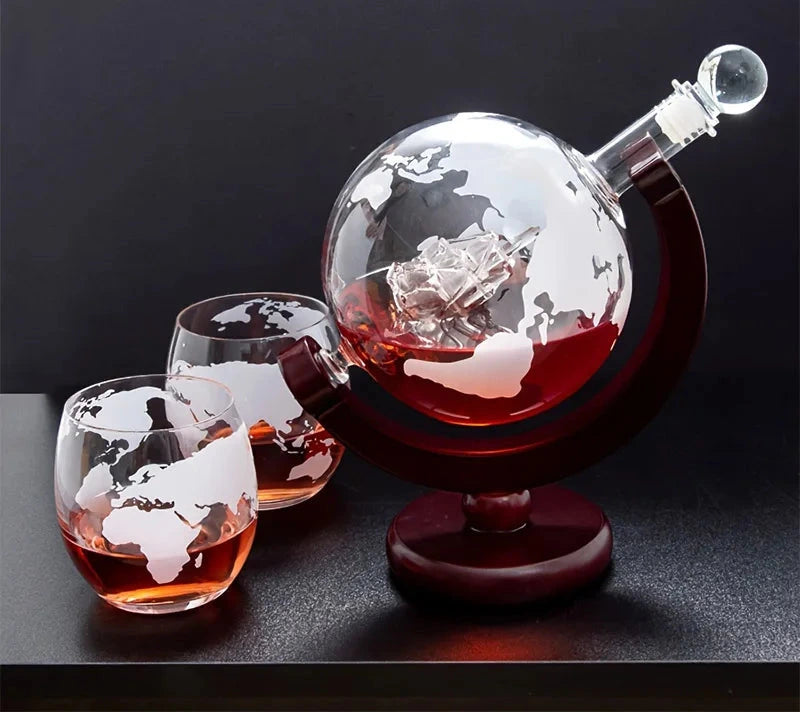 Globe Whiskey Decanter Set — decanter and etched globe glasses on a dark bar table